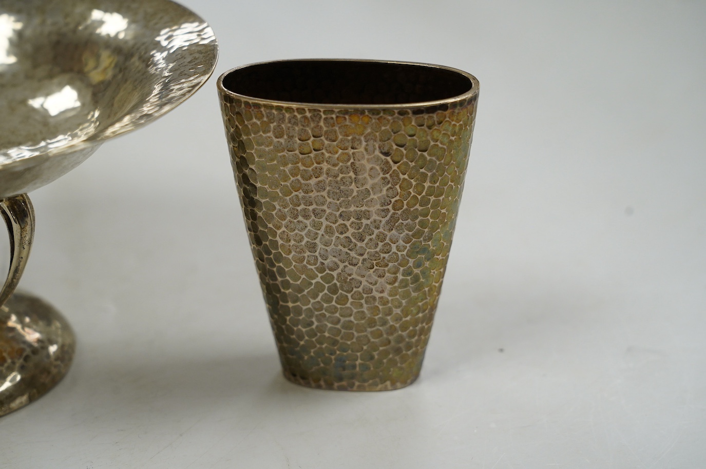 A George V Arts & Crafts planished silver bowl, on tripod supports and circular foot, Walker & Hall, Sheffield, 1912, diameter 15.7cm and a German planished vase inscribed 'Weihnachten 1897'. Condition - fair